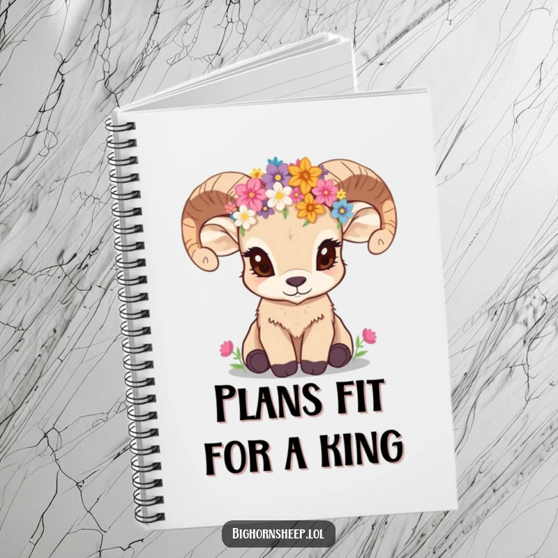 Funny bighorn sheep cub with wildflower crown, looking inquisitive, on the cover of a lined notebook.