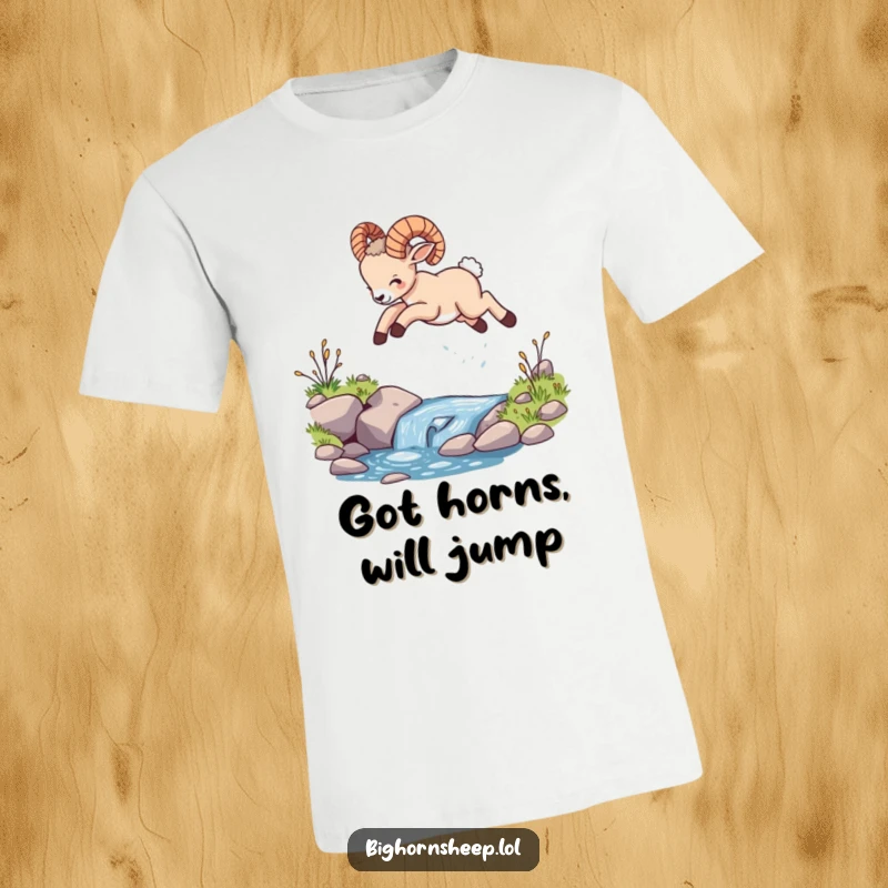 Funny bighorn sheep cub t-shirt, captured mid-leap over a small stream, exuding playful energy and wild, untamed joy.